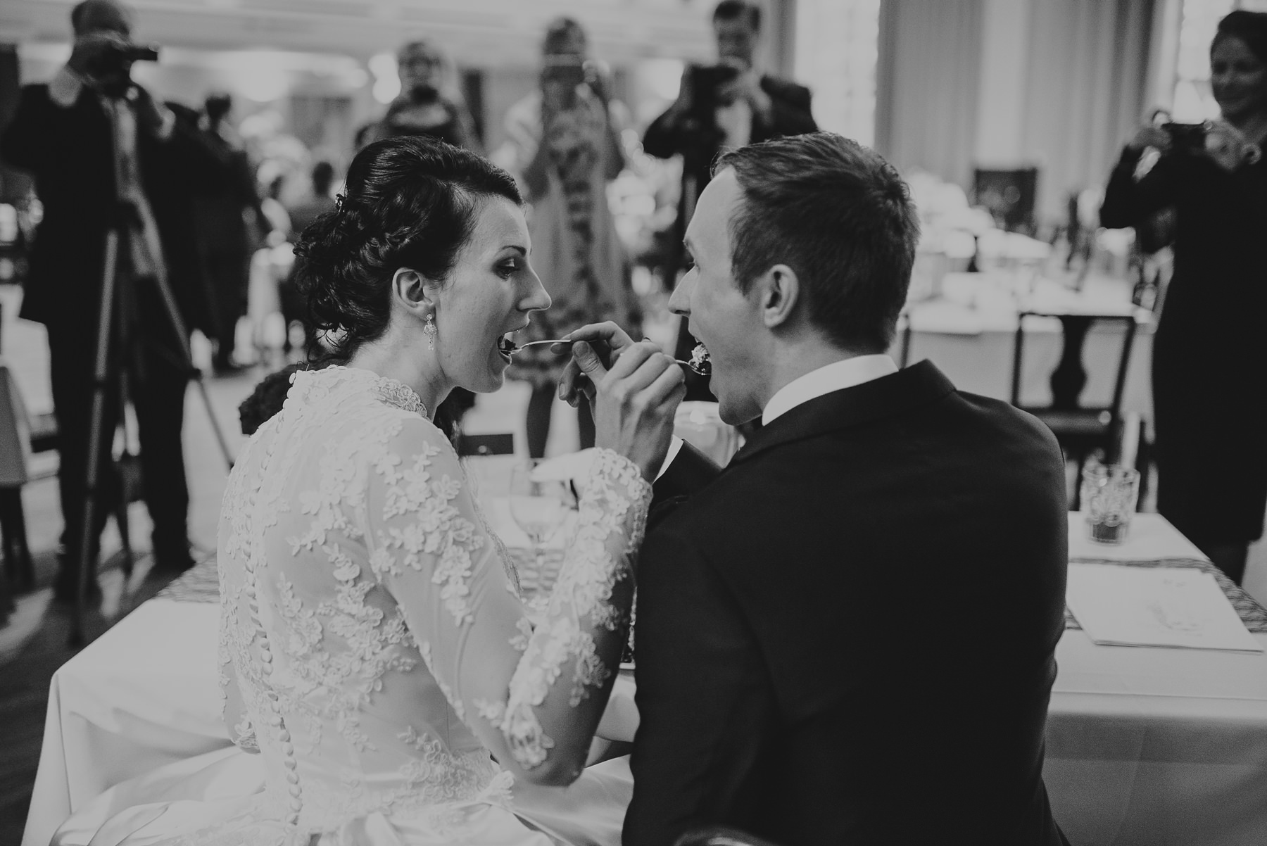 Bride and groom eating wedding cake